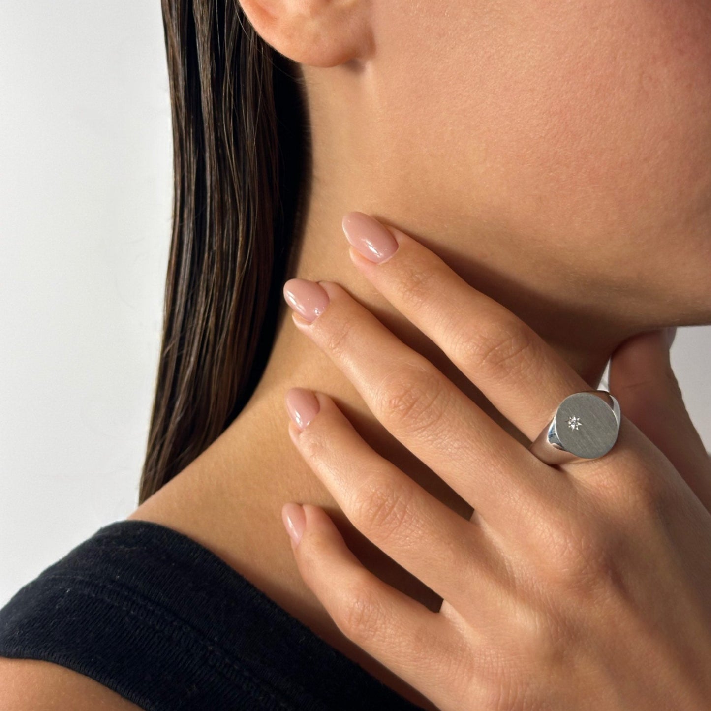 woman wearing classic silver signet ring natural round diamond