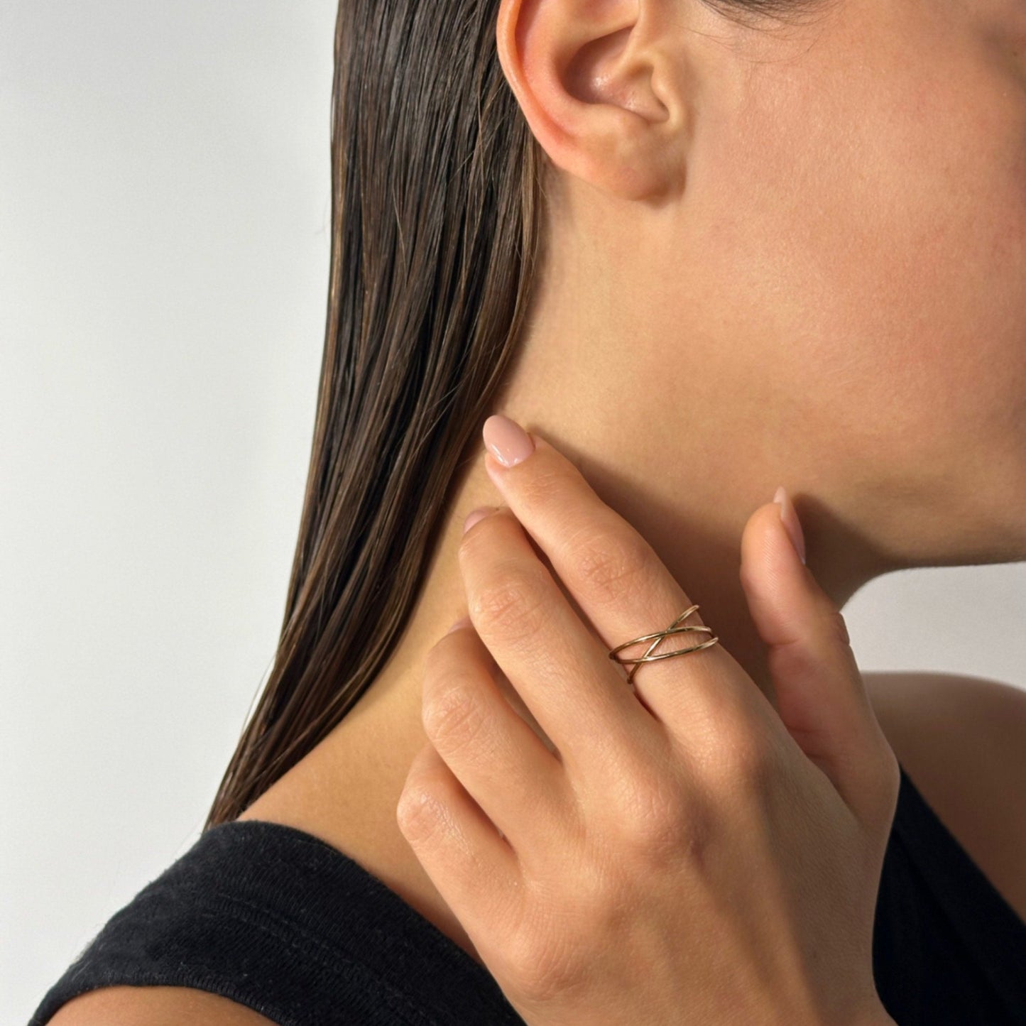 woman wearing 14k gold classic timeless statement interlocking band ring