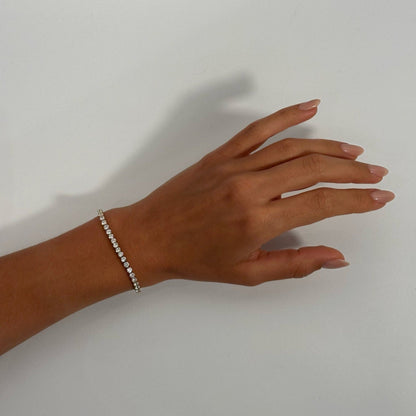 woman wearing 14k gold cubic zirconia classic timeless dainty tennis bracelet 