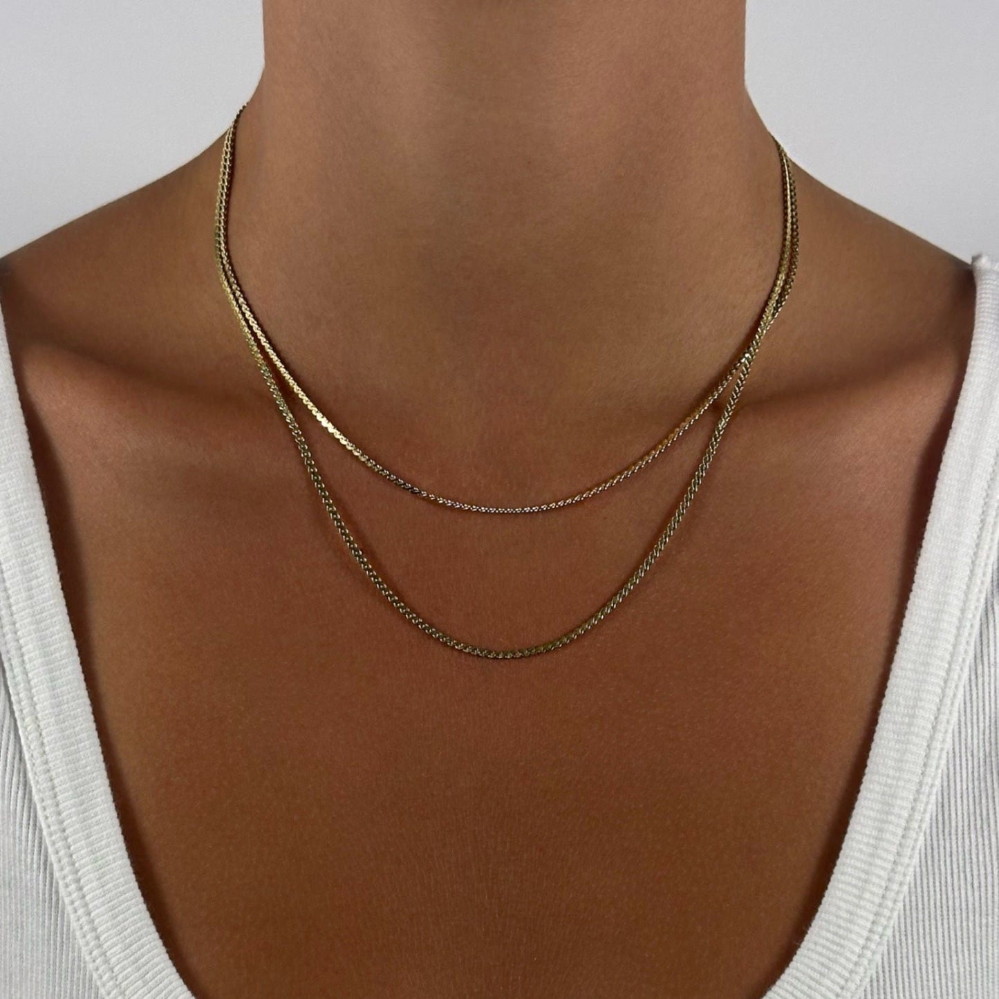 woman wearing 14k gold statement dainty timeless classic scroll chain necklace