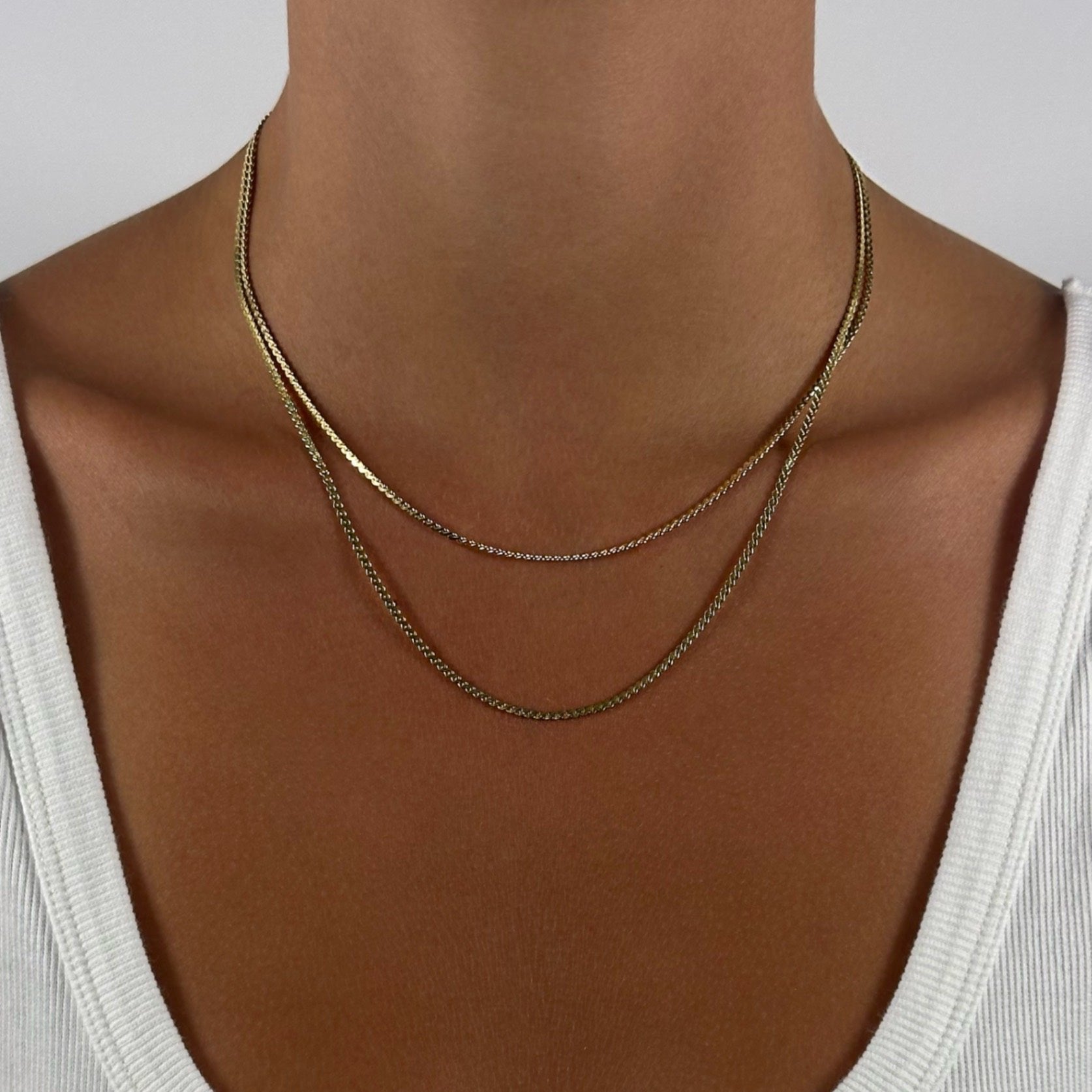 woman wearing 14k gold statement dainty timeless classic scroll chain necklace