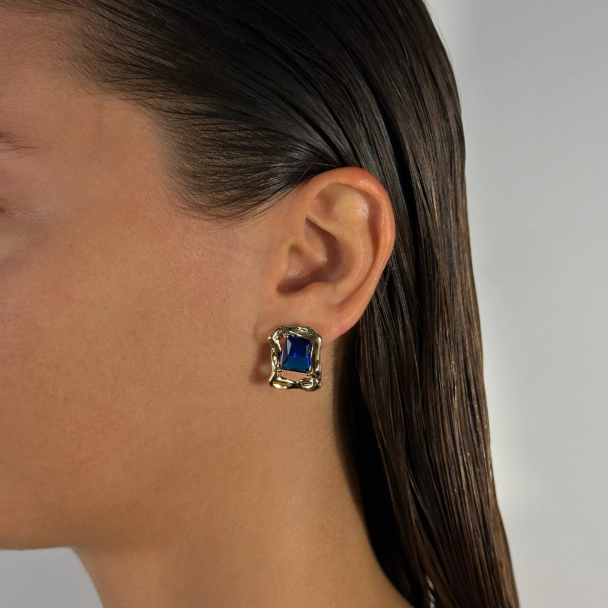 woman wearing 14k gold filled molten earrings blue lapis detail