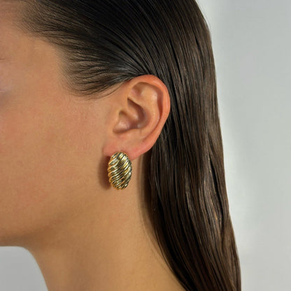 woman wearing 14k gold oval croissant lined statement classic earrrings 