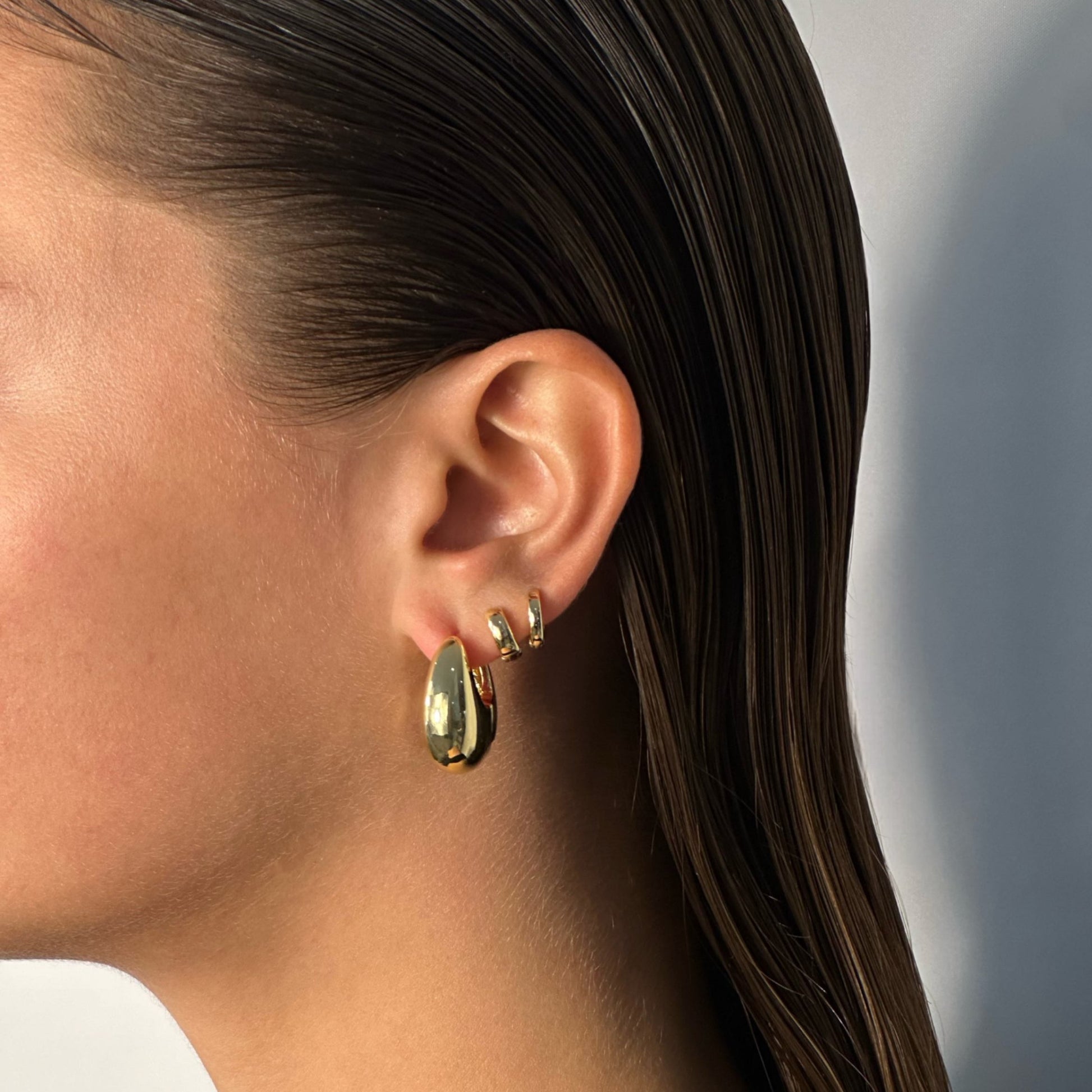 woman wearing 14k gold rounded statement chunky drop hoops desur