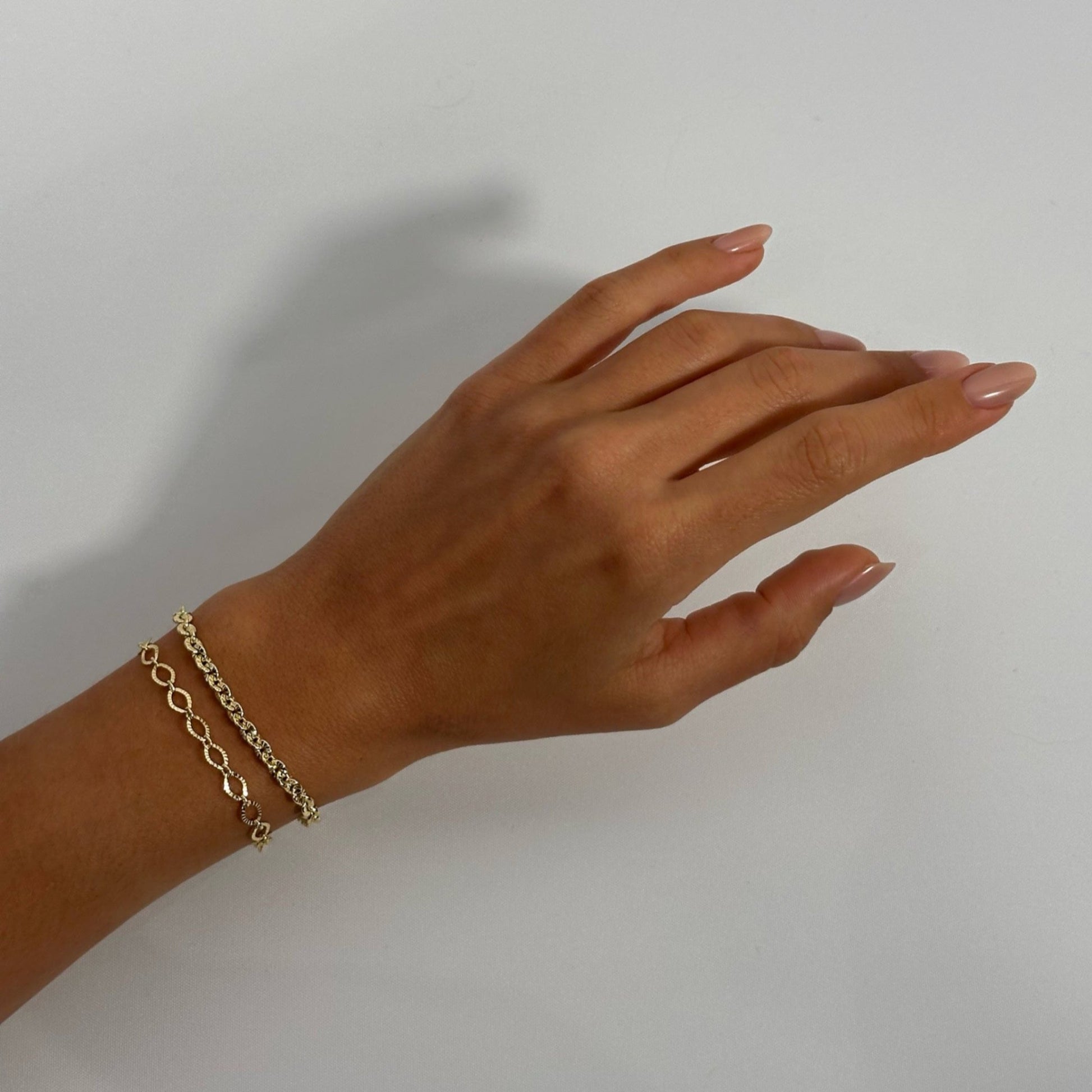 woman wearing 14k gold timeless dainty classic textured oval vintage chain bracelet