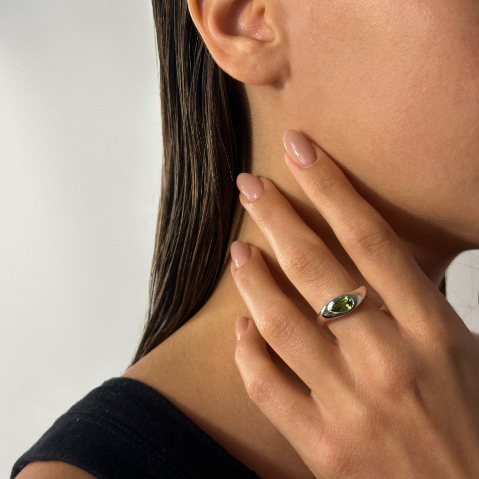 woman wearing classic timeless silver natural pear peridot ring 