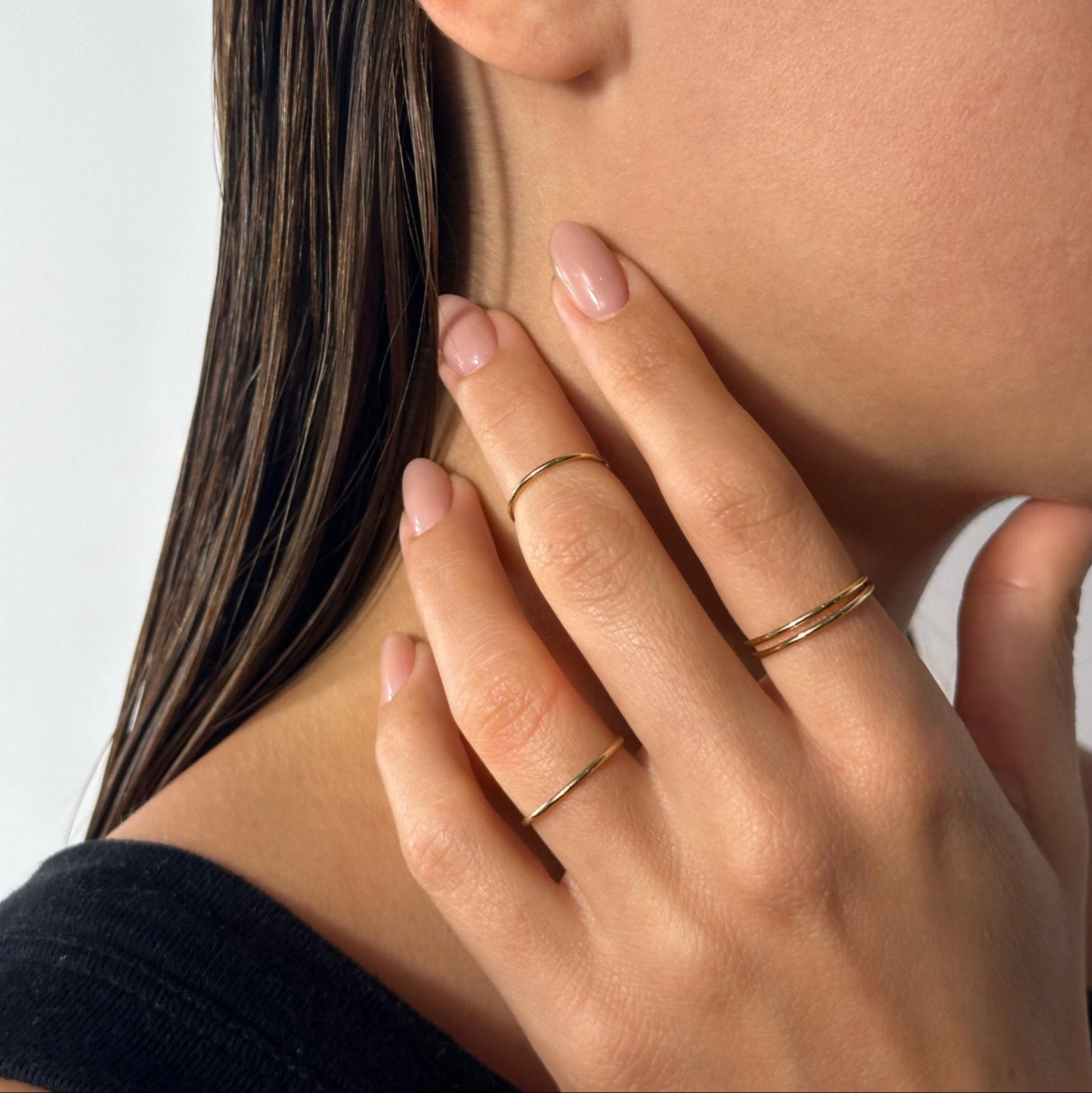 lady wearing gold classic fine band ring