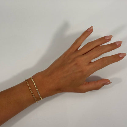 lady wearing gold dainty cable chain and scroll chain bracelet