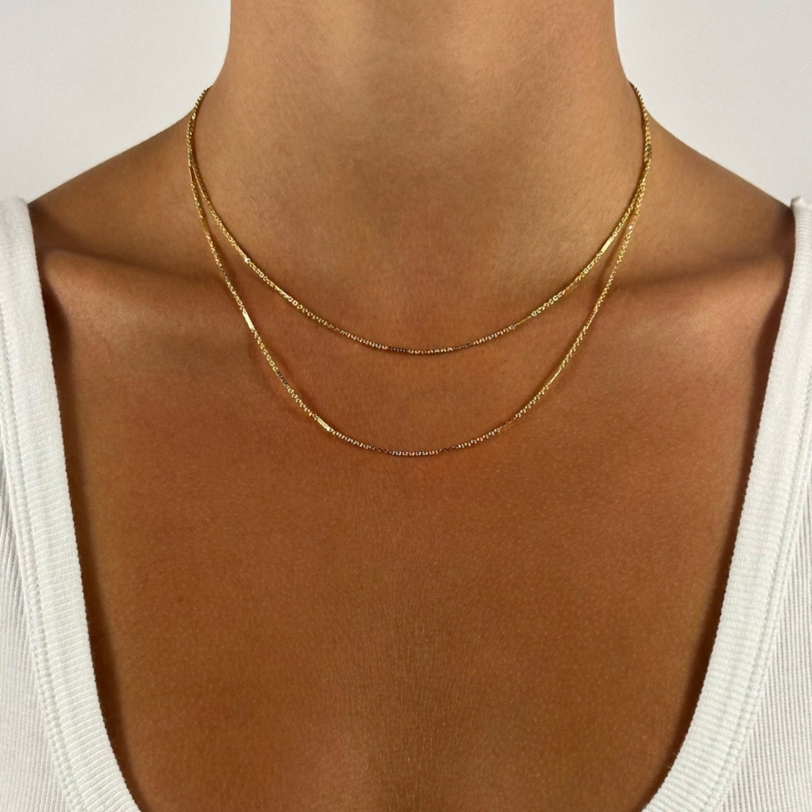 lady wearing gold dainty dapped cable necklace