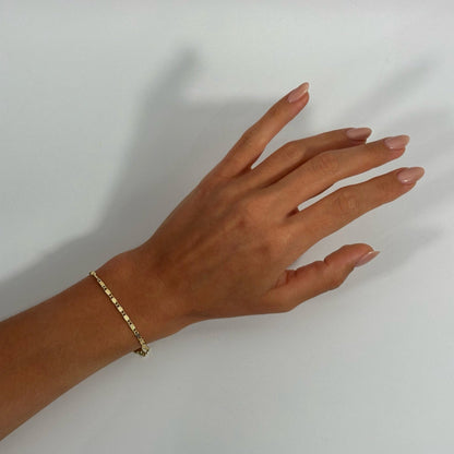 lady wearing gold dainty dotted scroll bracelet