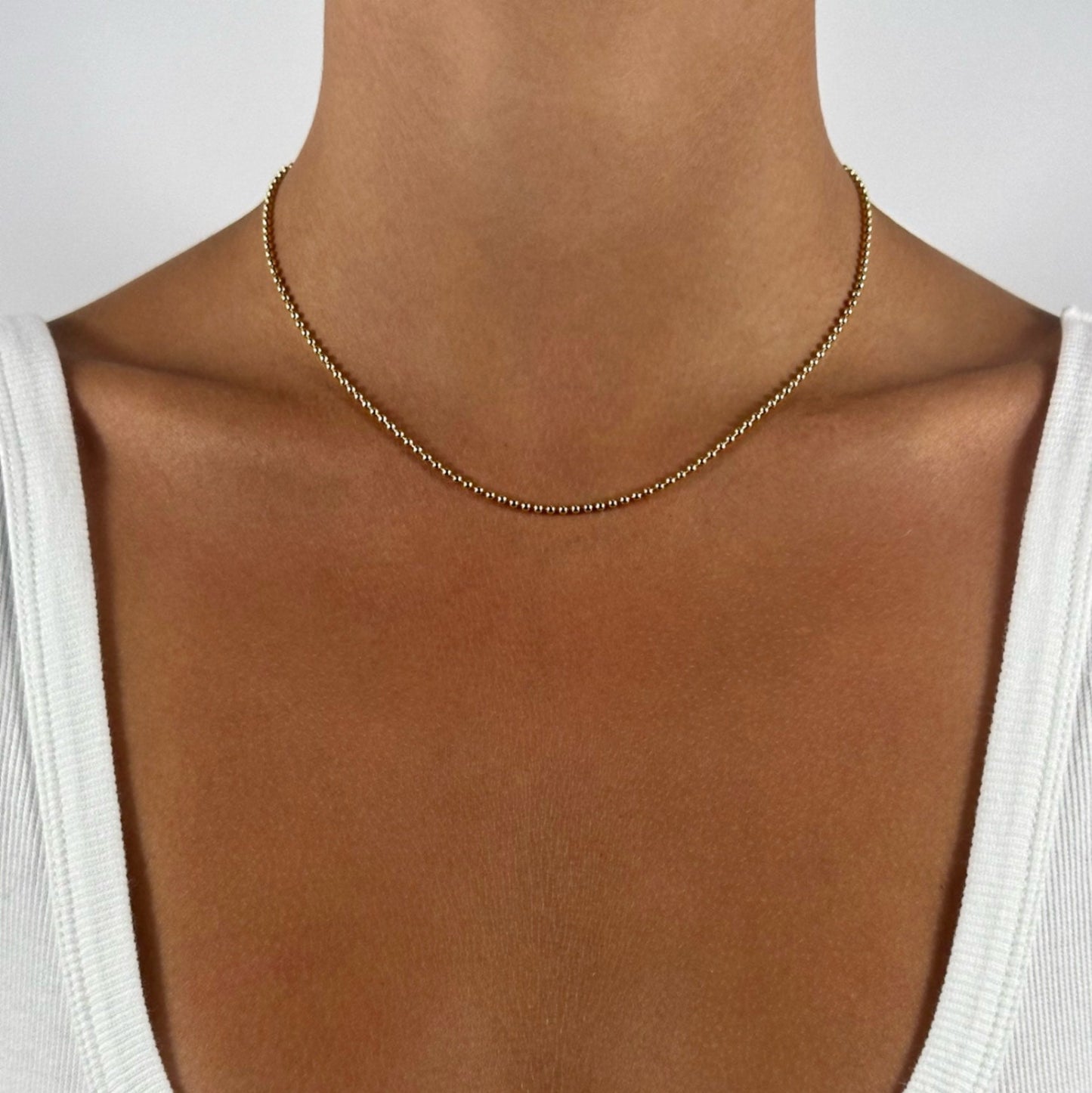 lady wearing gold filled bead chain necklace