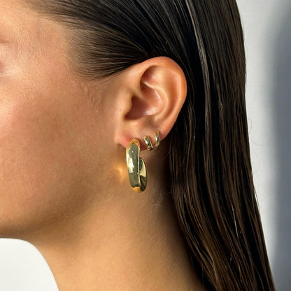 lady wearing gold statement edged hoops