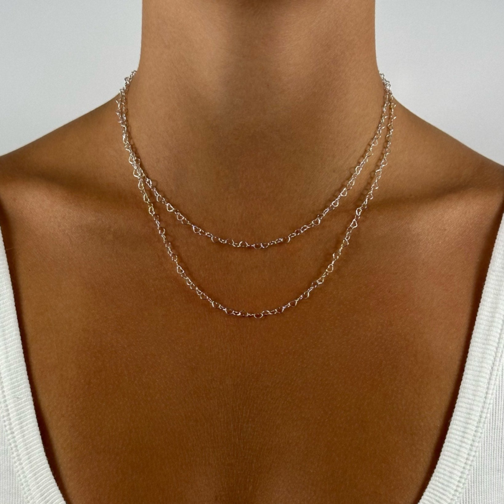 woman wearing silver classic dainty heart link chain necklace