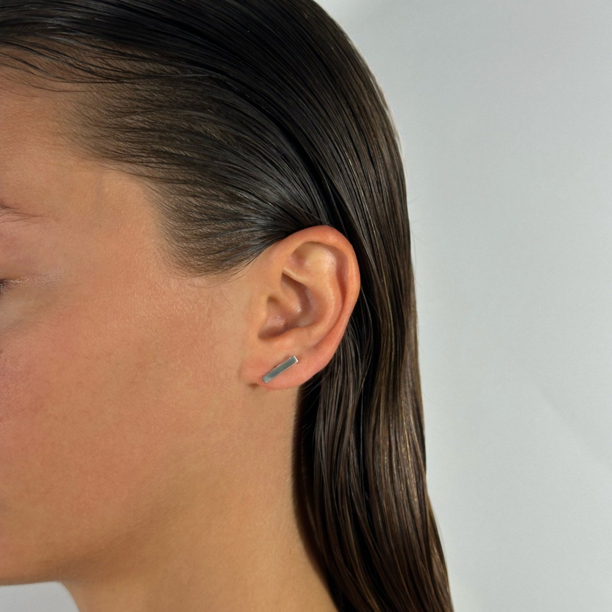 lady wearing sterling silver bar stud earrings