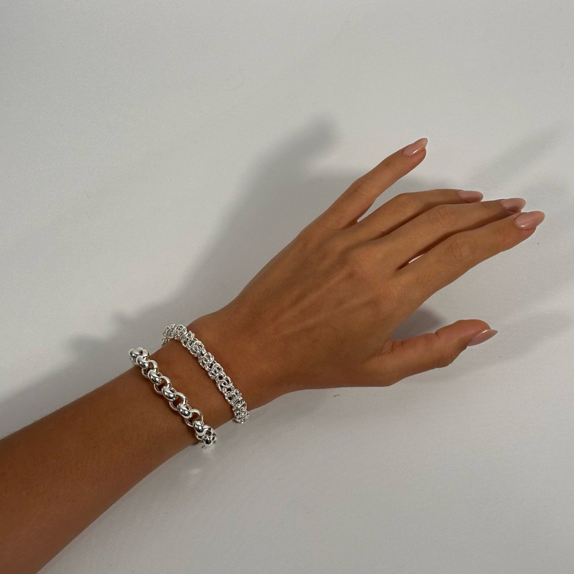 lady wearing sterling silver byzantine and silver rolo bracelet